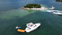 an aerial view of a boat in the water near an island
