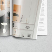 a magazine is open with a picture of a room