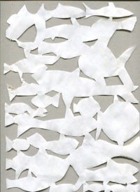 a white piece of paper with fish cut out of it