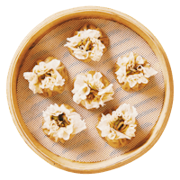 chinese dumplings in a bamboo basket on a black background