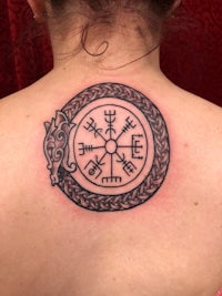 viking compass tattoo on the back of a woman