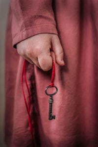 a woman's hand holding a key