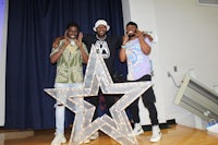 three men posing for a picture in front of a star