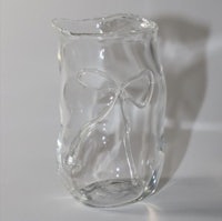 a glass vase with a bow on it