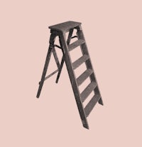 a wooden ladder on a pink background