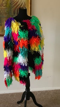 a colorful feather jacket on a mannequin