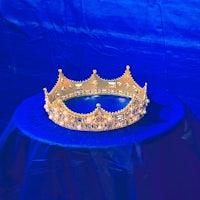 a gold crown on top of a blue cloth