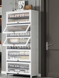 a white cabinet with shelves and drawers in a room