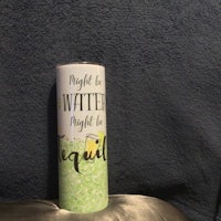 a tube of lip balm sitting on top of a pillow