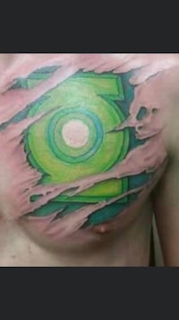 a green lantern tattoo on a man's chest