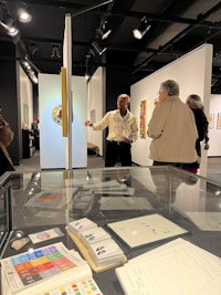 a group of people looking at a glass display case