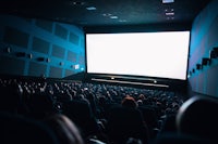 a crowd of people watching a movie in a theater