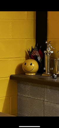a yellow wall with a smiley face on it