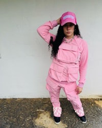 a woman wearing pink pants and a pink hat