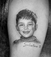 a tattoo of a boy with a smile on his leg