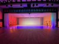a room with colorful lights and a wooden floor