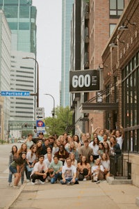 a group of people posing in front of a building