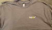 a gray t - shirt with a yellow logo on it