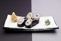 japanese sushi on a black and white plate