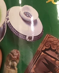a person is holding a book with a lot of chinese items on it