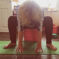 a woman doing yoga on a yoga mat