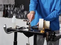 a man working on a machine in a workshop