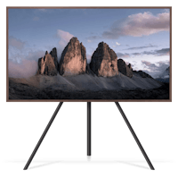 a tv on a tripod with mountains in the background