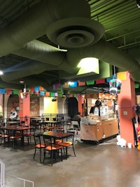 the inside of a mexican restaurant with tables and chairs