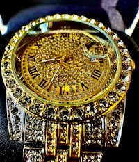 a gold watch with diamonds on it