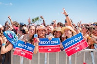 a group of people holding signs at a festival
