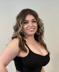 a woman in a black bra top posing for a photo