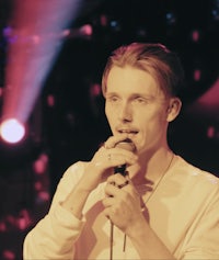 a man is singing into a microphone