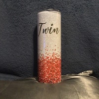 a can with the word twin on it sitting on top of a pillow