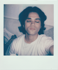 a polaroid photo of a man with his eyes closed