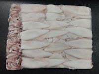 a white piece of meat is laid out on a table