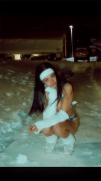 a woman crouching down in the snow