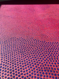 a red and blue rug with dots on it