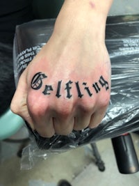 a person's hand with a tattoo on it that reads'gelling'