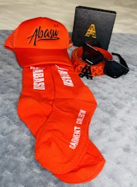 a pair of orange socks, a hat and a pair of sunglasses