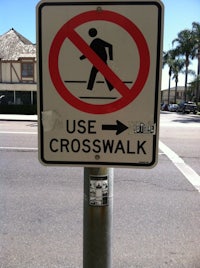 a no use crosswalk sign on a pole