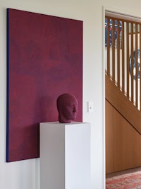 a painting on a pedestal in a room