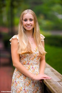 a girl in a floral dress is posing for a photo