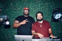 two men standing in front of a dj booth