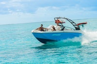 two people riding a speed boat in the ocean