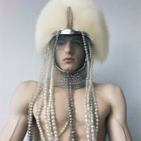 a mannequin wearing a fur hat and pearls
