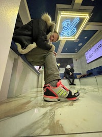 a man is sitting on a stair with his shoes on