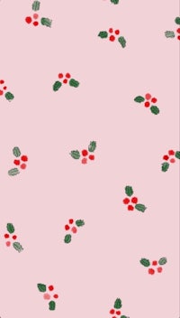 a pink fabric with holly berries on it