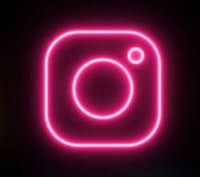 a pink neon instagram icon on a black background