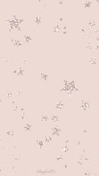 a pink background with white snowflakes on it