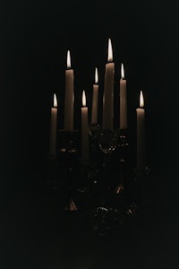 a group of candles lit in the dark